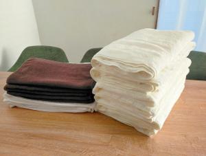 a stack of towels sitting on top of a table at Frog Inn - Entire House for Private Use in Fujinomiya +97 photos