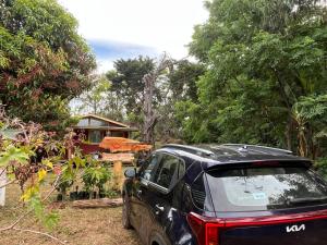 a black car parked in front of a house at Cabaña Rei miro in Hanga Roa