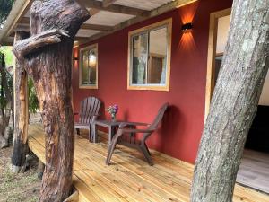 a house with a table and chairs on a deck at Cabaña Rei miro in Hanga Roa +9 photos