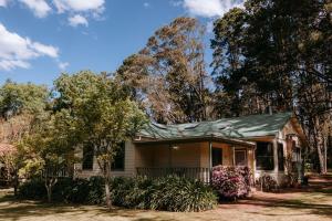 a small house with a green roof at Federation Gardens & Possums Hideaway in Blackheath