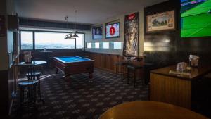 a bar with a pool table and a tv at Gladstone Reef Hotel Motel in Gladstone