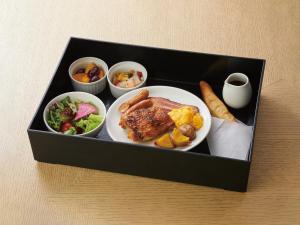 a black lunch box with a plate of food at Agora Kyoto Karasuma in Kyoto