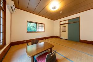 an empty room with a wooden table and chairs at YUPOPPO Hakone in Hakone +27 photos