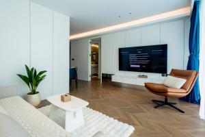 a living room with a couch and a tv at Kora 2br pool Apartment in Layan Beach
