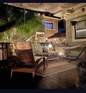 a rocking chair and a hammock on a deck at Garden Suite- Private Deck, Hot Tub & Fast WiFi in Vallejo