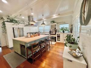 a kitchen with a large island with bar chairs at Garden Suite- Private Deck, Hot Tub & Fast WiFi in Vallejo