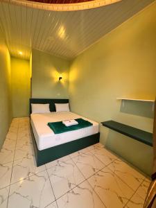 En eller flere senge i et værelse på Ingan Cio Homestay