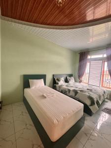 En eller flere senge i et værelse på Ingan Cio Homestay