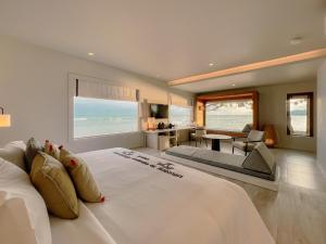 a bedroom with a large bed with a view of the ocean at Rocky's Boutique Resort - Veranda Collection Samui in Lamai