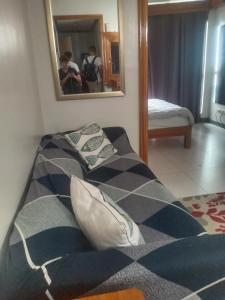 two beds in a room with a mirror at KL Rooms at Greenbelt makati with cityview in Manila +3 photos