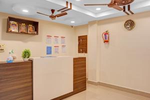 a waiting room with a ceiling fan and a counter at Hotel O Ramya Inn in Warangal