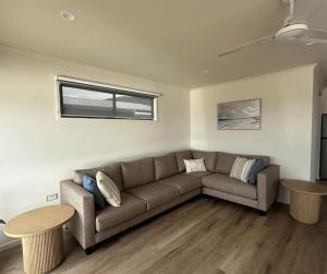 a living room with a couch and a table at BIG4 Apollo Bay Pisces Holiday Park in Apollo Bay