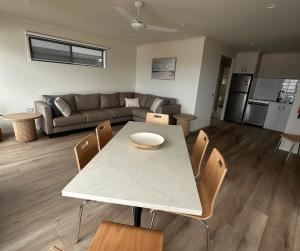 a kitchen and living room with a table and chairs at BIG4 Apollo Bay Pisces Holiday Park in Apollo Bay