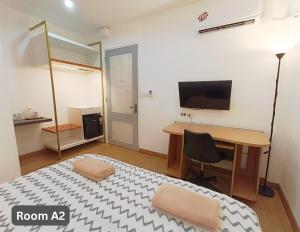 a room with a desk and a table with a chair at Friend Nest Bangkok in Bangkok