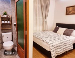 a bathroom with a bed and a toilet in a room at Friend Nest Bangkok in Bangkok +66 photos