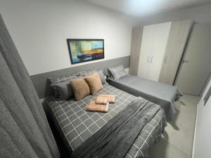 Кровать или кровати в номере Apartamento- ótima localização-aconchegante e completo no Centro - SJC