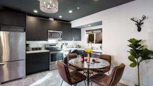 a kitchen with a table and chairs and a refrigerator at Rock n Roll by AvantStay Vibey 2BDR in Prime Hollywood Steps to Attractions in Los Angeles