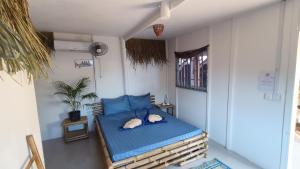 a small bedroom with a blue bed in a room at Paradiso Village Center Bungalows in Koh Rong Island
