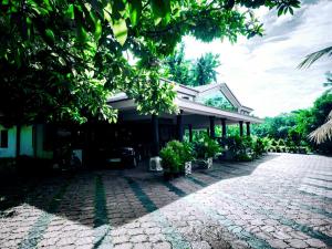 a building with a cobblestone road in front of it at GB25 inn in Trivandrum