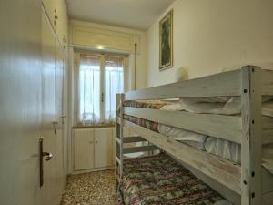 a bedroom with a wooden bunk bed in a room at Huge Holiday Home in Marina di Castagneto Carducci near Sea in Donoratico +33 photos