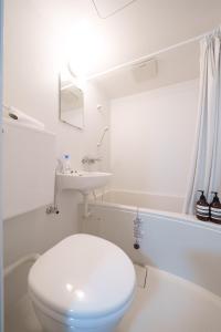 a white bathroom with a toilet and a sink at 3min walk to Asagaya Sta, Cozy Private Studio Direct access 8min to Shinjuku, 30min to Akihabara and Asakusa in Tokyo