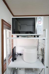 a microwave sitting on top of a white shelf at 3min walk to Asagaya Sta, Cozy Private Studio Direct access 8min to Shinjuku, 30min to Akihabara and Asakusa in Tokyo +35 photos