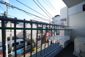 a balcony with a view of a train at 3min walk to Asagaya Sta, Cozy Private Studio Direct access 8min to Shinjuku, 30min to Akihabara and Asakusa in Tokyo