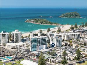 an aerial view of a city with a beach and buildings at 2 Room Luxury Beach Escape 112sq Mt Maunganui in Mount Maunganui