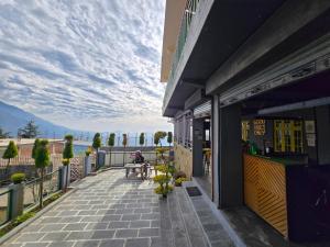 a balcony of a building with a view of the ocean at East Home Stay in Dharmsala