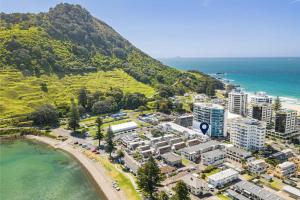 an aerial view of a city next to the ocean at Luxury Beach Escape - 6 Adams Ave Mt Maunganui in Mount Maunganui