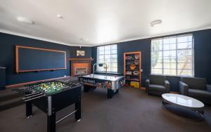 a living room with a pool table and a tv at The Hallows Accommodation in Bathurst