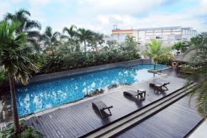 an overhead view of a swimming pool in a building at Hotel Santika Tasikmalaya in Tasikmalaya