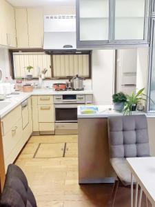 a kitchen with white cabinets and a stove top oven at 烟雨轩301新 in Tokyo