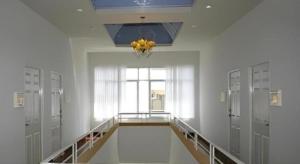 a hallway with lockers and a chandelier in a room at Warina Place Hotel in Ao Nang 