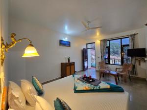 a living room with a bed and a lamp at East Home Stay in Dharmsala