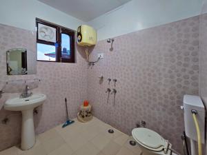 a bathroom with a sink and a toilet at East Home Stay in Dharmsala +60 photos