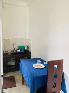 a blue table with a plate of food on it at Relax Corner in Hiriketiya +16 photos