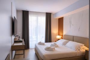 En eller flere senge i et værelse på Hotiday Lerici Porto