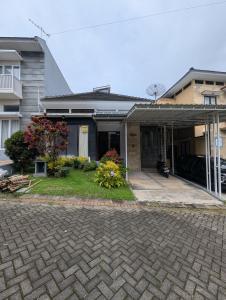 a house with a brick driveway in front of it at Villa Kusuma Pinus M10 in Batu