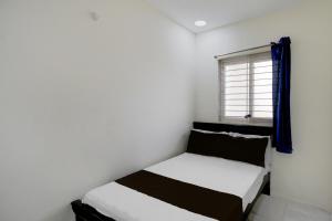 a bedroom with two beds and a window at Hotel O Film City Hyderabad Formerly RJ Residency in Pedda Ambarpet +23 photos