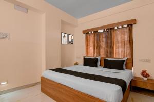 a bedroom with a large bed and a window at Super Collection O Biswa Bangla Convention Centre Kolkata Formerly Atithya Inn in New Town