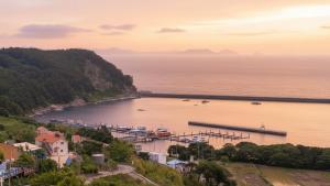 a view of a body of water with boats docked at Namhae JJhouse Pension in Namhae