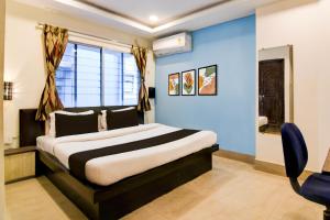 Postel nebo postele na pokoji v ubytování Collection O Techno India University Saltlake Formerly A&M Regency