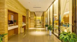 a hallway of a building with plants in it at Jinjiang Inn Select Xixian New Distict Century Avenue in Xianyang