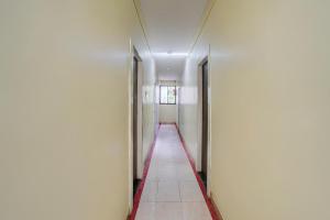 舍地Super Hotel O Sainagar Shirdi Railway Junction Formerly Sai Vyankatesh Residency的空荡荡的建筑走廊，门都开着
