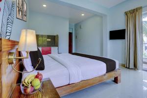 1 dormitorio con 1 cama y un plato de fruta en una mesa en Super Collection O Siolim Formerly Celeb Da Luna, en Agarvado 30 fotos más