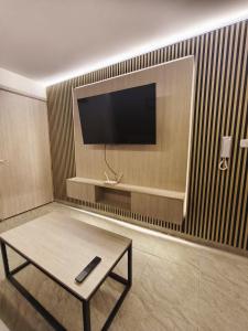 a living room with a tv and a coffee table at Barranquero Coffee Loft in Santa Rosa de Cabal