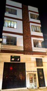 a tall building with two entrances to a store at Barranquero Coffee Loft in Santa Rosa de Cabal