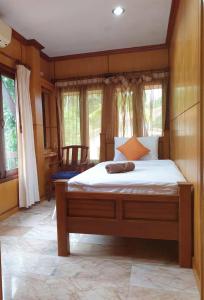 a bedroom with a large bed in a room with windows at Thai House by Dow Residence in Lamai
