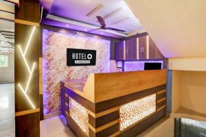 a hotel lobby with a kocho sign on the wall at Super Hotel O Rajahmundry Central Railway Station Formerly Sanjeevi Residency in Godāvari